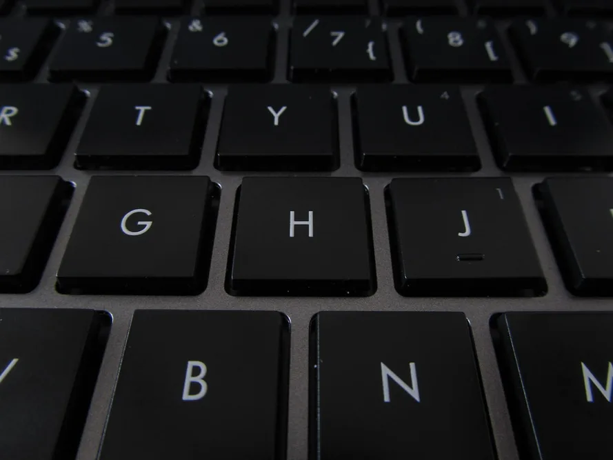 close-up ปุ่มคีย์บอร์ดโน้ตบุ๊คสีดำ แสดงคุณภาพและความละเอียดของปุ่ม
